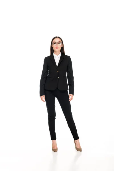 Full length view of confident businesswoman in black suit with crossed arms isolated on white — Stock Photo