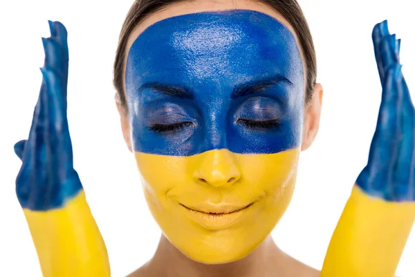 Young woman with painted Ukrainian flag on skin and closed eyes isolated on white — Stock Photo