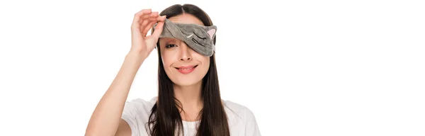 Smiling brunette young woman in cat sleeping eye mask isolated on white, panoramic shot — Stock Photo