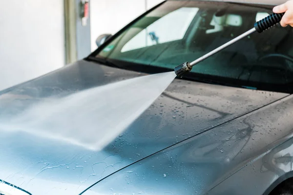 Cropped view of car cleaner washing grey auto outside — Stock Photo