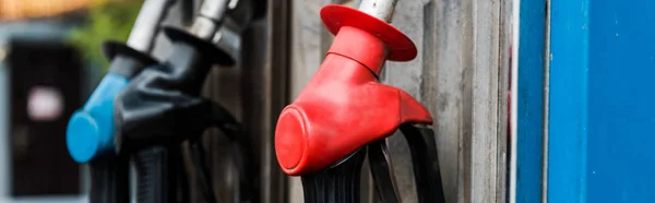 Panoramic shot of gas pumps with fuel on gas station — Stock Photo