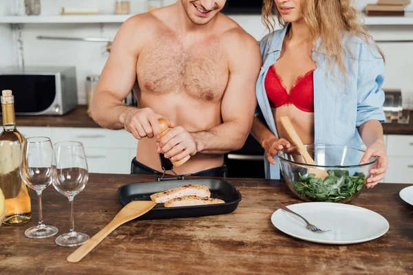 Cropped view of sexy couple cooking together in kitchen — Stock Photo