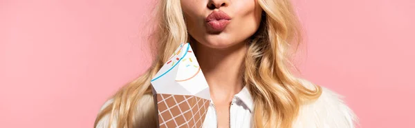 Partial view of beautiful blonde woman with decorative ice cream pouting lips isolated on pink, panoramic shot — Stock Photo