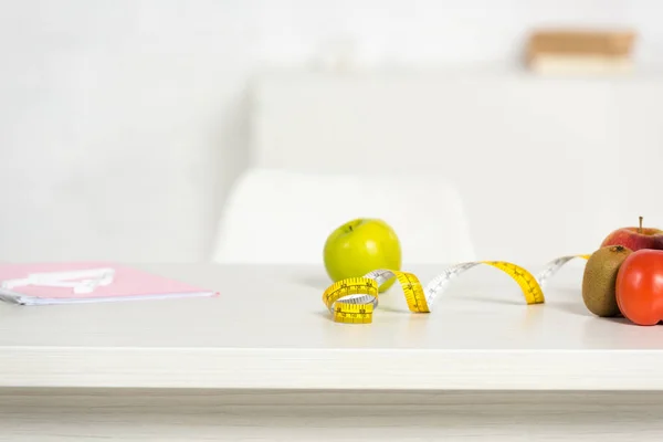 Folder, measure tape and fresh food on table — Stock Photo