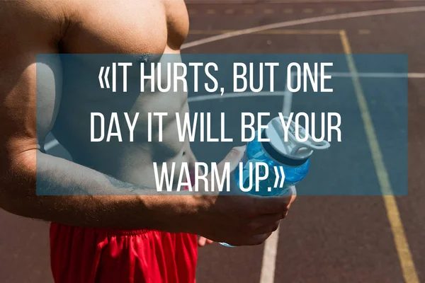 It hurts, but one day it will be your warm up lettering on partial view of shirtless muscular sportsman holding sport bottle — Stock Photo