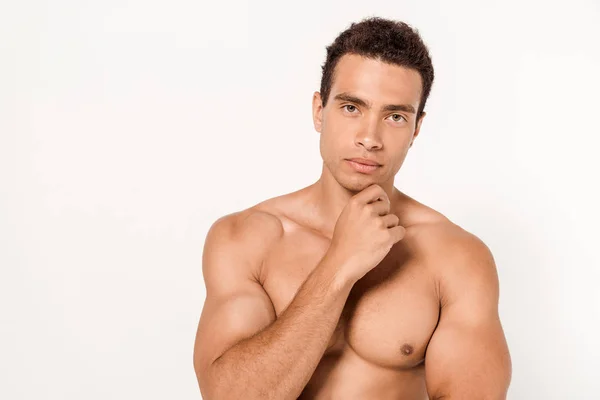 Pensive mixed race man touching chin while standing on white — Stock Photo