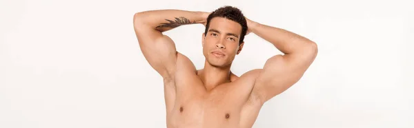 Panoramic shot of handsome mixed race man with tattoo looking at camera on white — Stock Photo