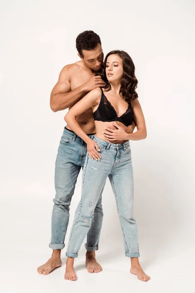 Shirtless mixed race man standing with attractive girl on white — Stock Photo