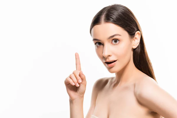 Beautiful young woman with perfect skin looking at camera while showing idea gesture isolated on white — Stock Photo