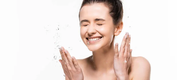 Happy naked young brunette woman with natural beauty and closed eyes washing up with clean water splash isolated on white, panoramic shot — Stock Photo
