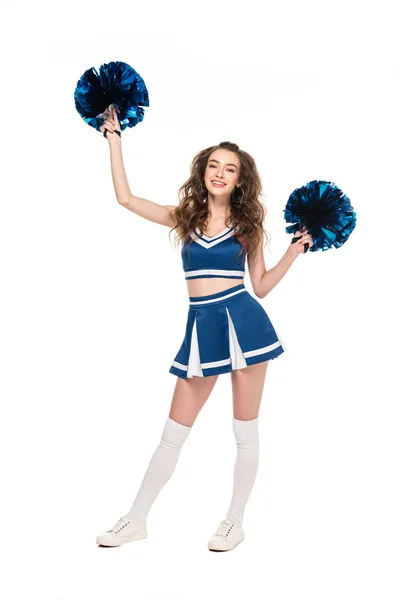 Full length view of happy cheerleader girl in blue uniform dancing with pompoms isolated on white — Stock Photo