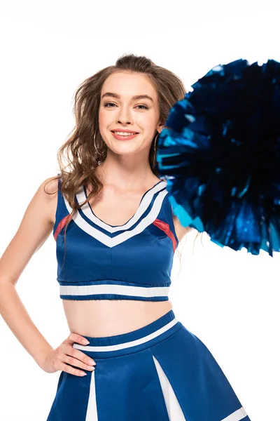 Happy beautiful cheerleader girl in blue uniform holding pompom isolated on white — Stock Photo