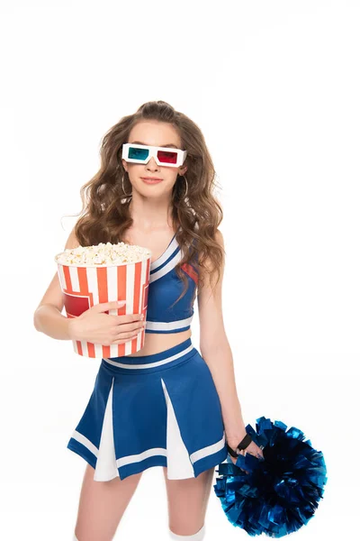 Sexy cheerleader girl in blue uniform and 3d glasses with pompom and bucket of popcorn isolated on white — Stock Photo