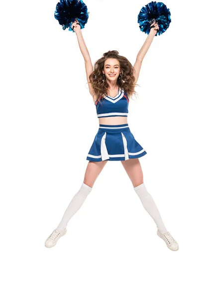 Happy cheerleader girl in blue uniform and gaiters jumping with pompoms isolated on white — Stock Photo