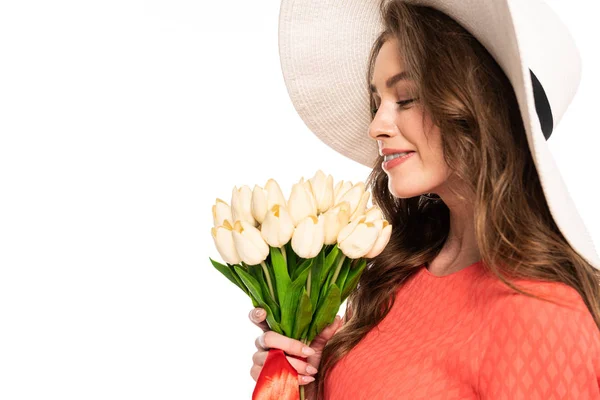Elegant woman in hat holding white tulips isolated on white — Stock Photo