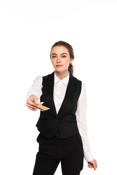 Young waitress holding credit card isolated on white — Stock Photo
