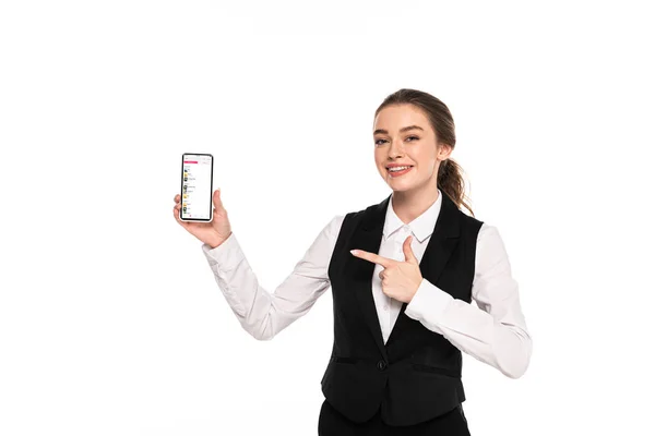 KYIV, UKRAINE - APRIL 7, 2019: happy young waitress pointing with finger at apple music app on smartphone isolated on white — Stock Photo