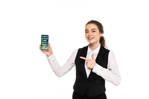 KYIV, UKRAINE - APRIL 7, 2019: happy young waitress pointing with finger at iphone isolated on white — Stock Photo