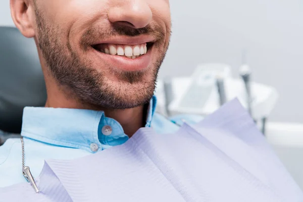 Cropped view of happy patient smiling in dental clinic — Stock Photo