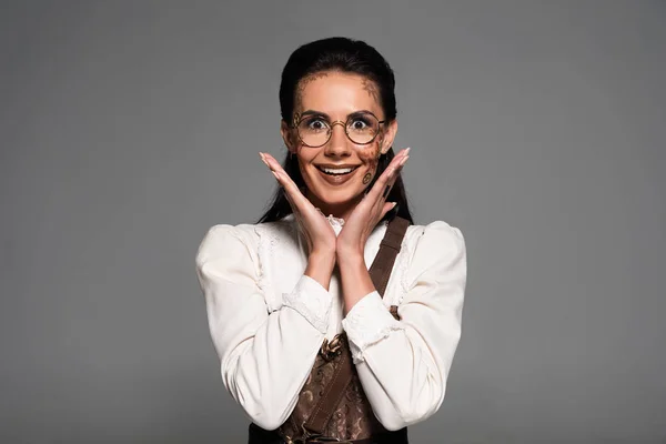 Front view of excited attractive steampunk woman smiling isolated on grey — Stock Photo