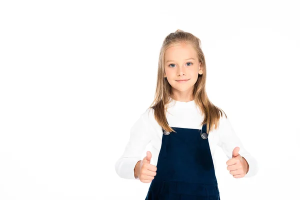 Cute schoolgirl showing thumbs up while looking at camera isolated on white — Stock Photo