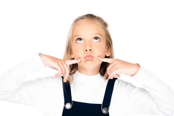 Thoughtful schoolgirl looking up while holding hands near face isolated on white — Stock Photo