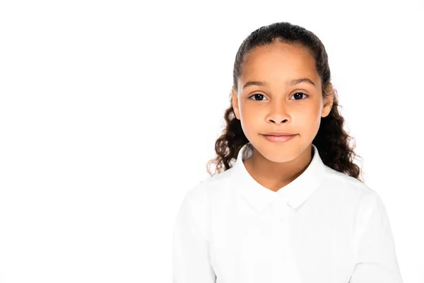 Cute, cheerful african american schoolgirl smiling at camera isolated on white — Stock Photo