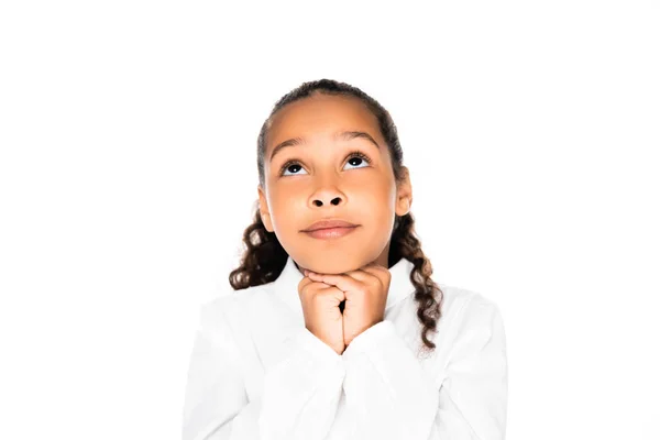 Adorable african american schoolgirl looking up and showing please gesture isolated on white — Stock Photo