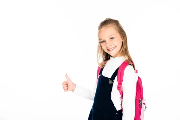 Cheerful schoolgirl showing thumb up while smiling at camera isolated on white — Stock Photo