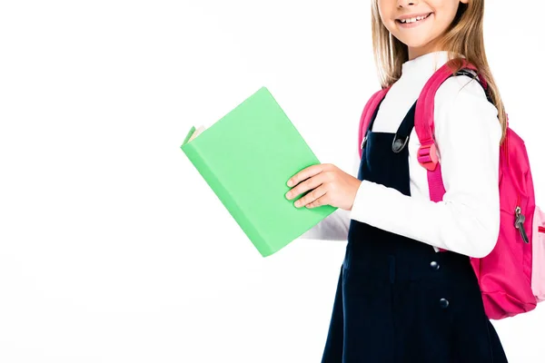 Vue recadrée d'écolière souriante tenant livre isolé sur blanc — Photo de stock