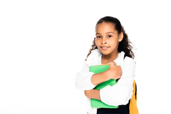 Adorable afro-américaine écolière tenant des livres et regardant caméra isolé sur blanc — Photo de stock