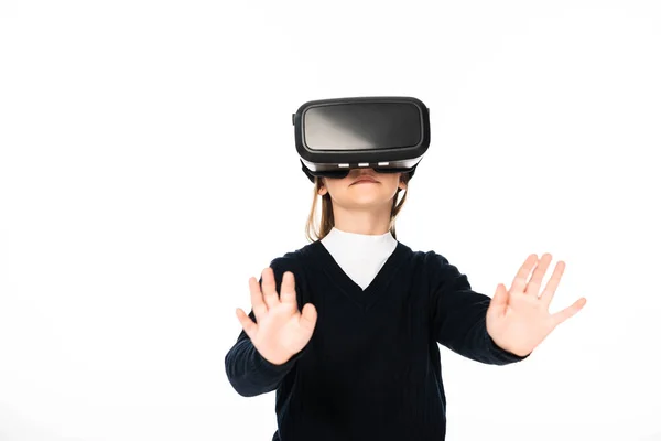 Schoolgirl gesturing while using virtual reality headset isolated on white — Stock Photo