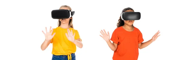 Panoramic shot of two multicultural friends using virtual reality headsets isolated on white — Stock Photo