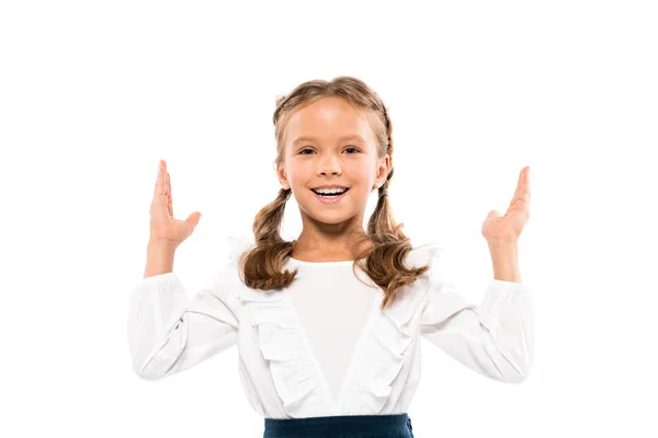 Cheerful kid gesturing while looking at camera isolated on white — Stock Photo