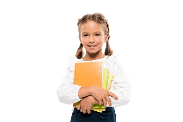 Feliz colegial sosteniendo libros aislados en blanco - foto de stock