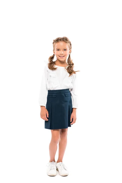 Happy schoolgirl smiling and standing isolated on white — Stock Photo