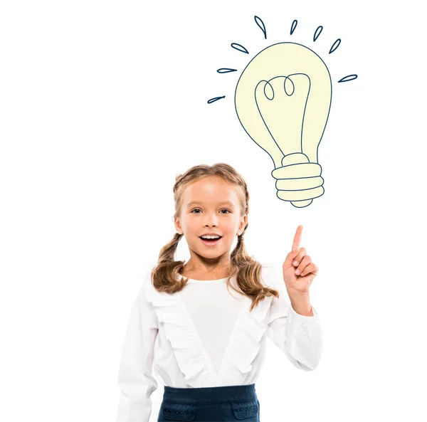 Happy kid pointing with finger at light bulb while having idea on white — Stock Photo