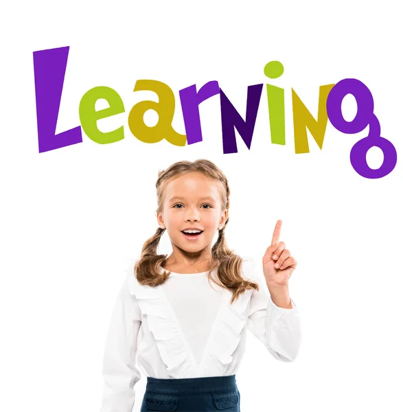 Happy kid pointing with finger at learning lettering on white — Stock Photo