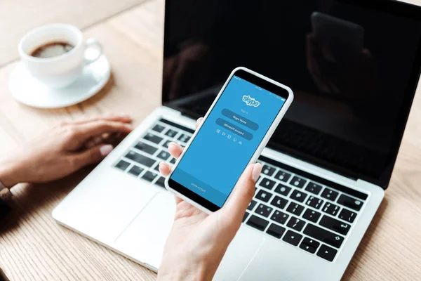 KYIV, UKRAINE - AUGUST 5, 2019: cropped view of woman holding smartphone with skype app — Stock Photo