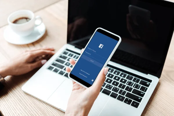 KYIV, UKRAINE - AUGUST 5, 2019: cropped view of woman holding smartphone with facebook app — Stock Photo