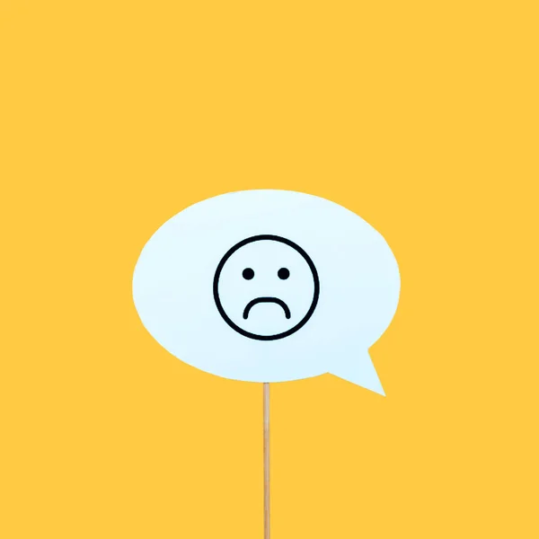 KYIV, UKRAINE - AUGUST 5, 2019: sad face on speech bubble isolated on orange — Stock Photo