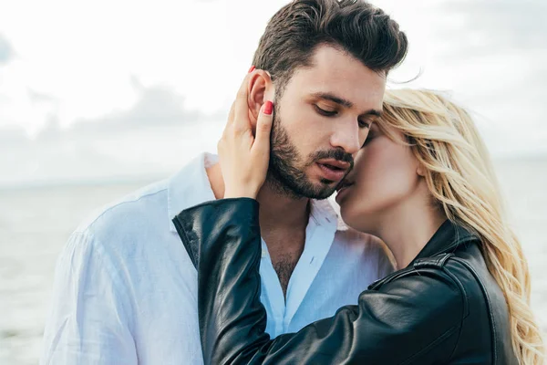 Attractive woman and handsome man smiling and hugging outside — Stock Photo