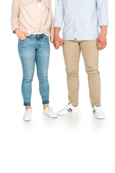 Cropped view of young man and woman holding hands on white background — Stock Photo