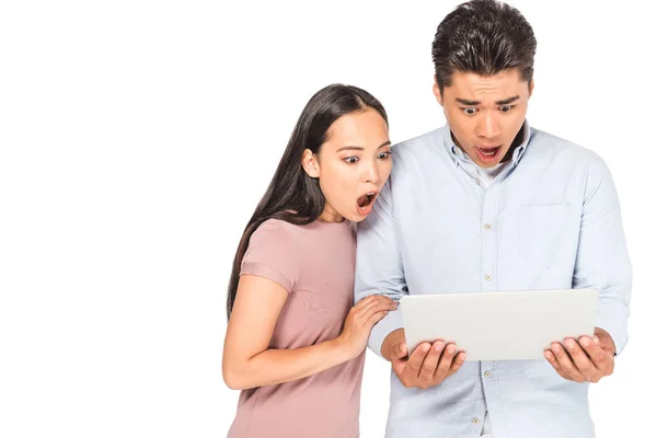 Shocked asian man and woman looking at laptop isolated on white — Stock Photo