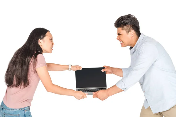 Irritated asian man and woman holding laptop with blank screen isolated on white — Stock Photo