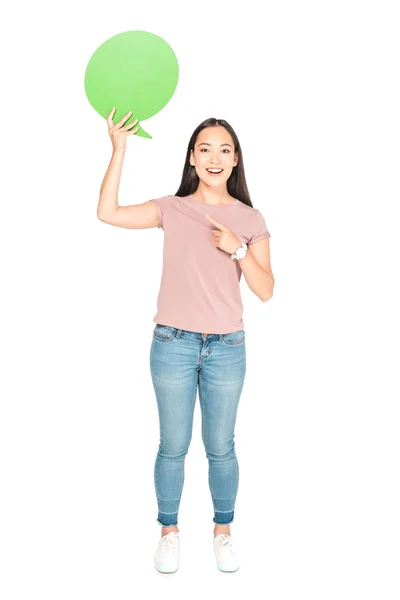 Beautiful asian girl pointing with finger at blank thought bubble on white background — Stock Photo