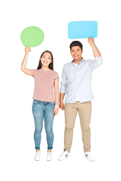 Asian man with speech bubble and girl with thought bubble smiling at camera on white background — Stock Photo