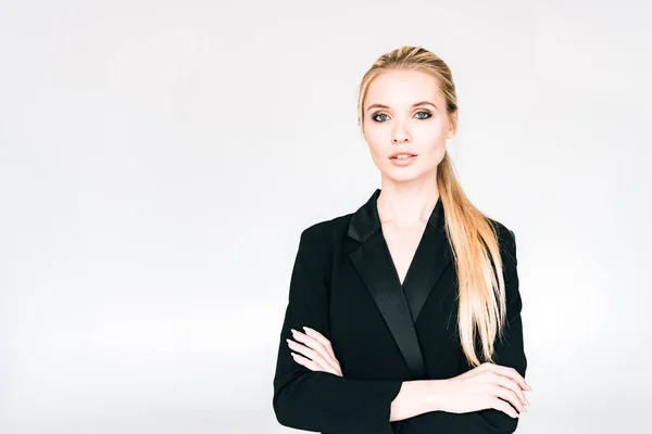 Elegant blonde woman in black outfit with crossed arms isolated on grey — Stock Photo