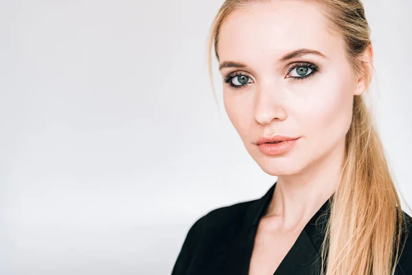 Portrait of elegant blonde woman in black outfit isolated on grey — Stock Photo