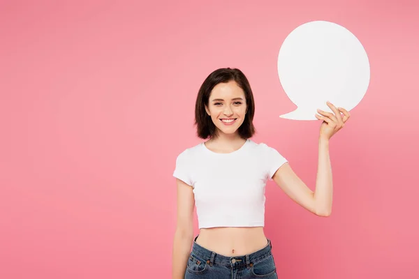 Smiling pretty girl holding blank white speech bubble isolated on pink — Stock Photo